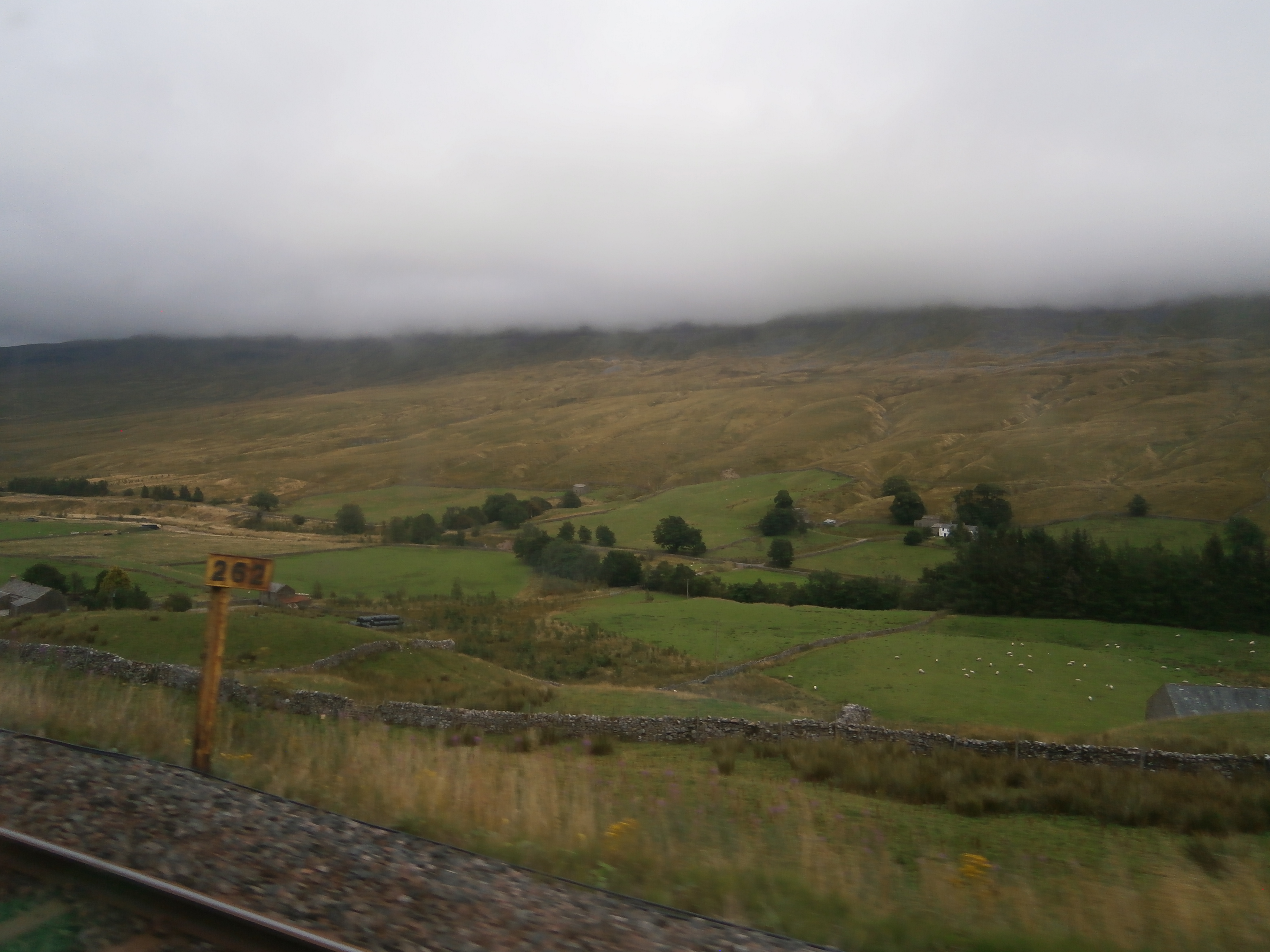 Photo of hills and rolling countryside plus a milepost