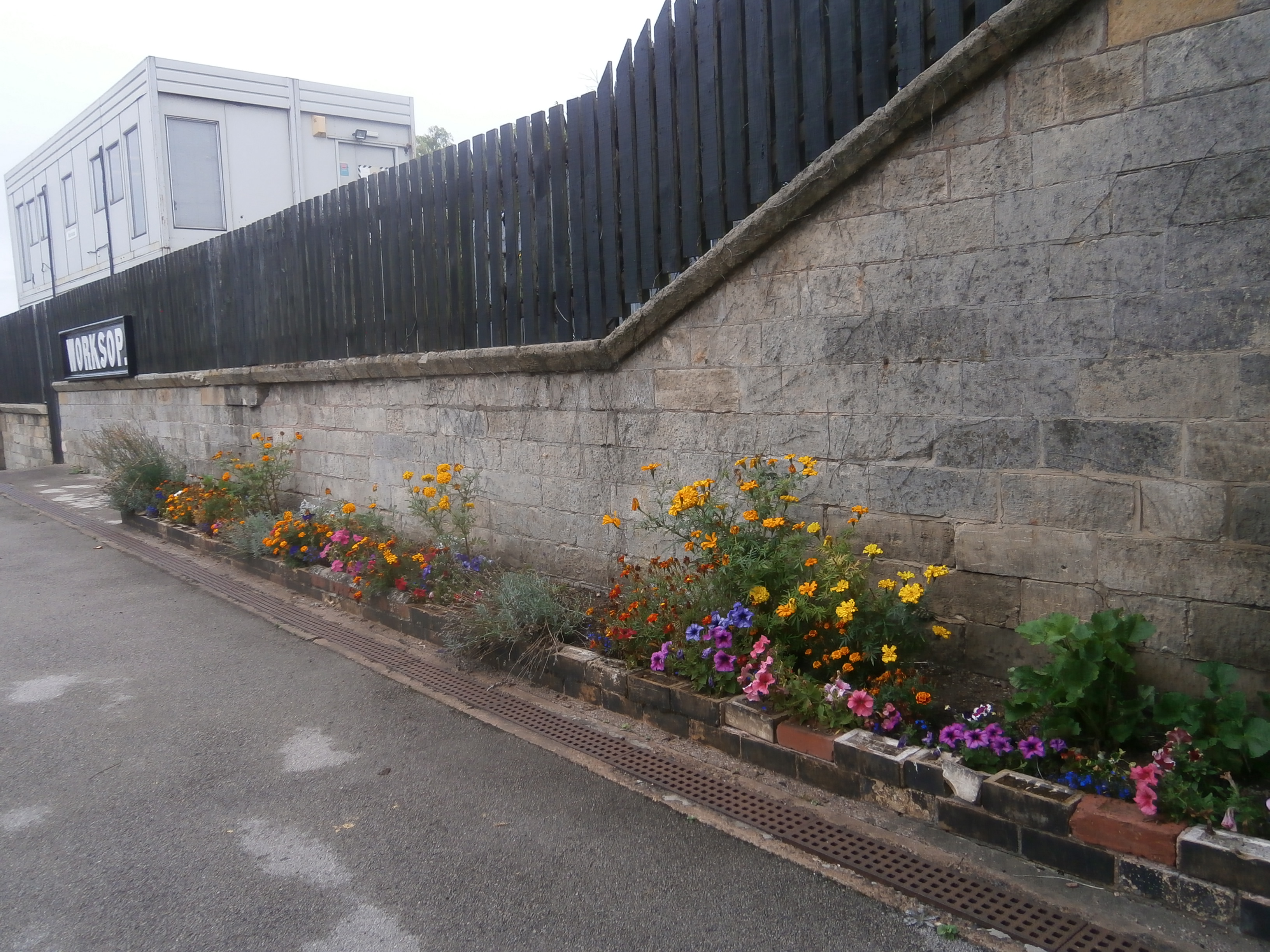 Photo of sign and flowers at Worksop station