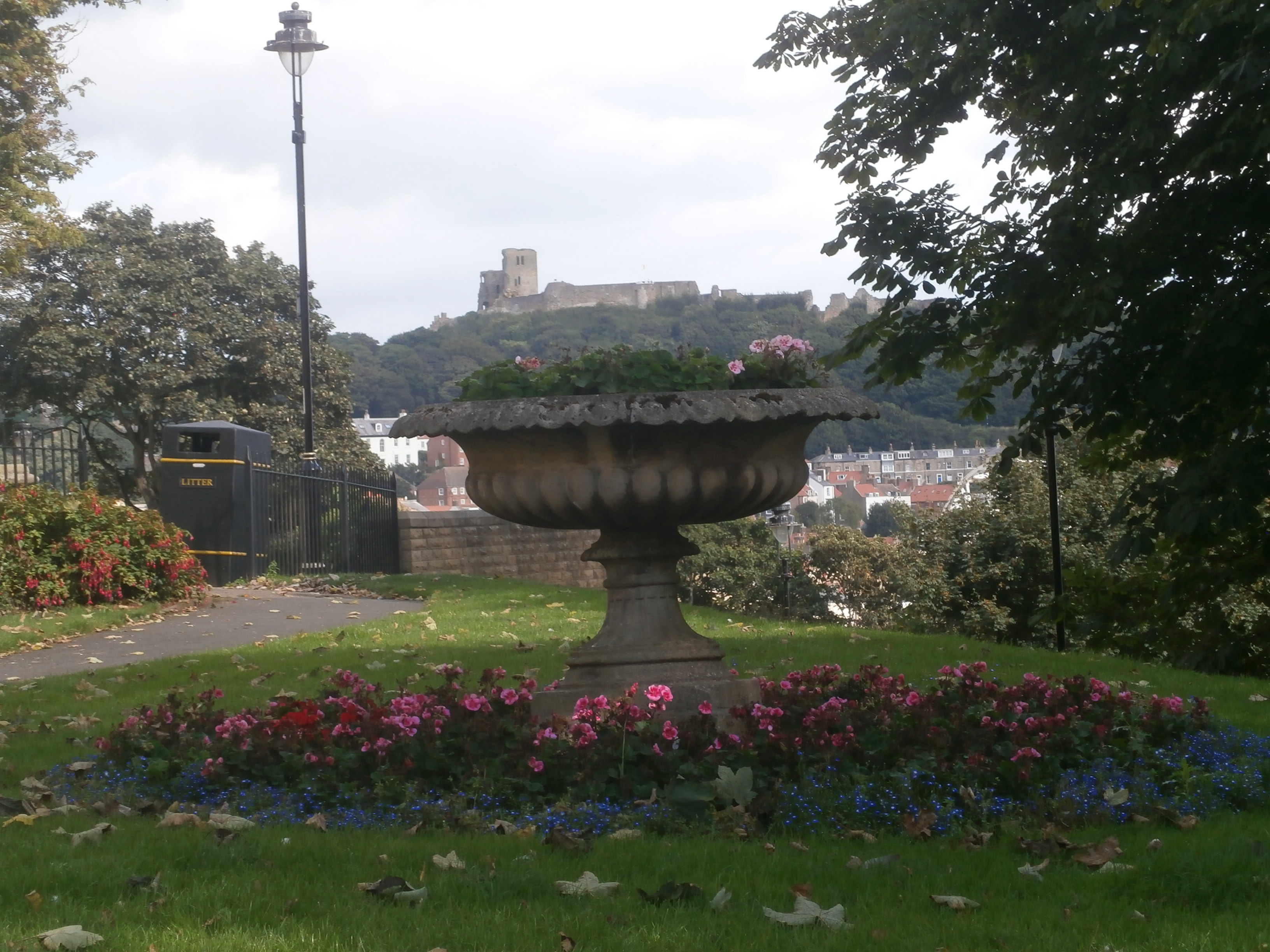 Photo of Scarborough castle in the background and flowers in the foreground