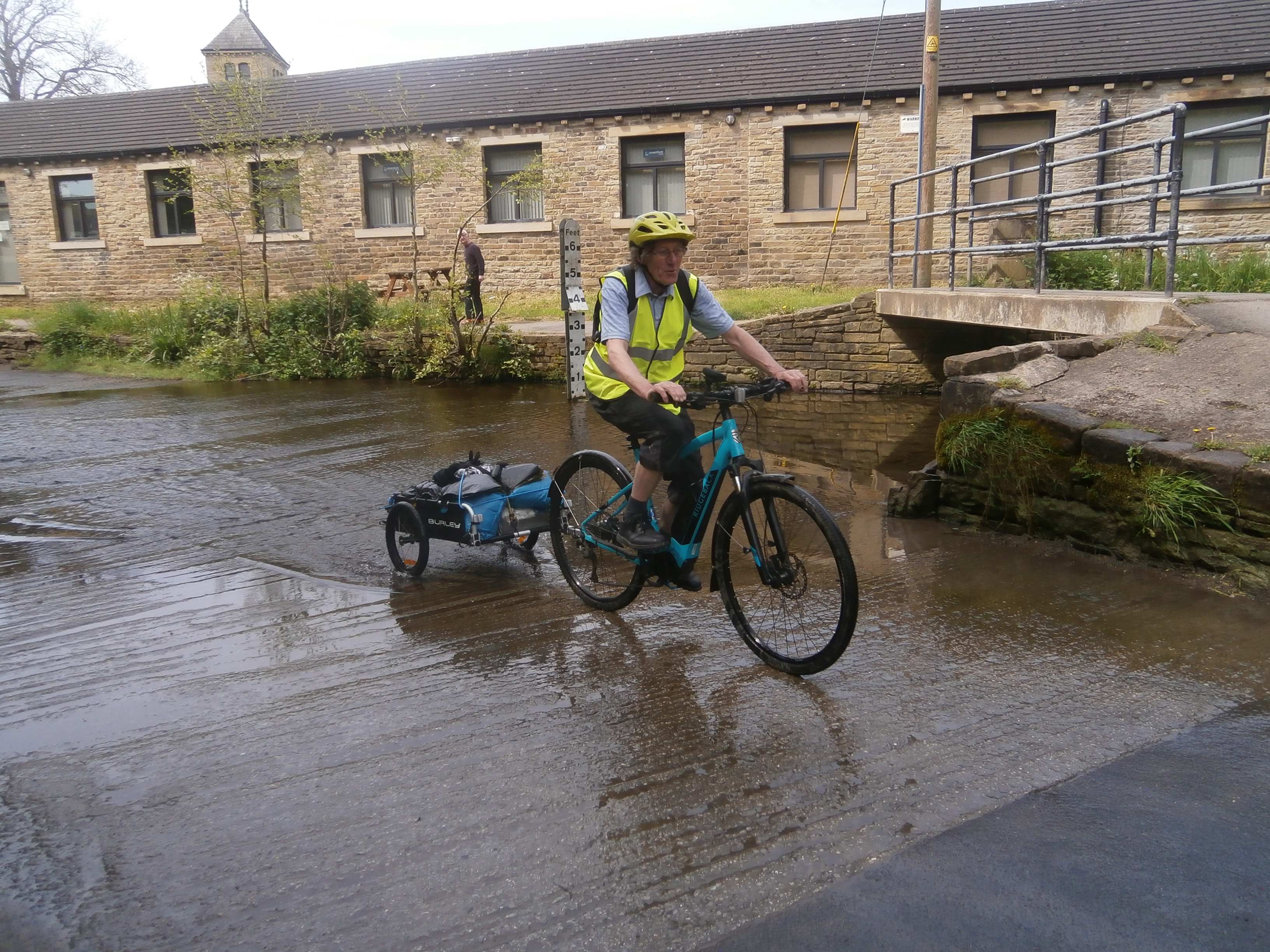 Photo of cyclist with trailer going through ford