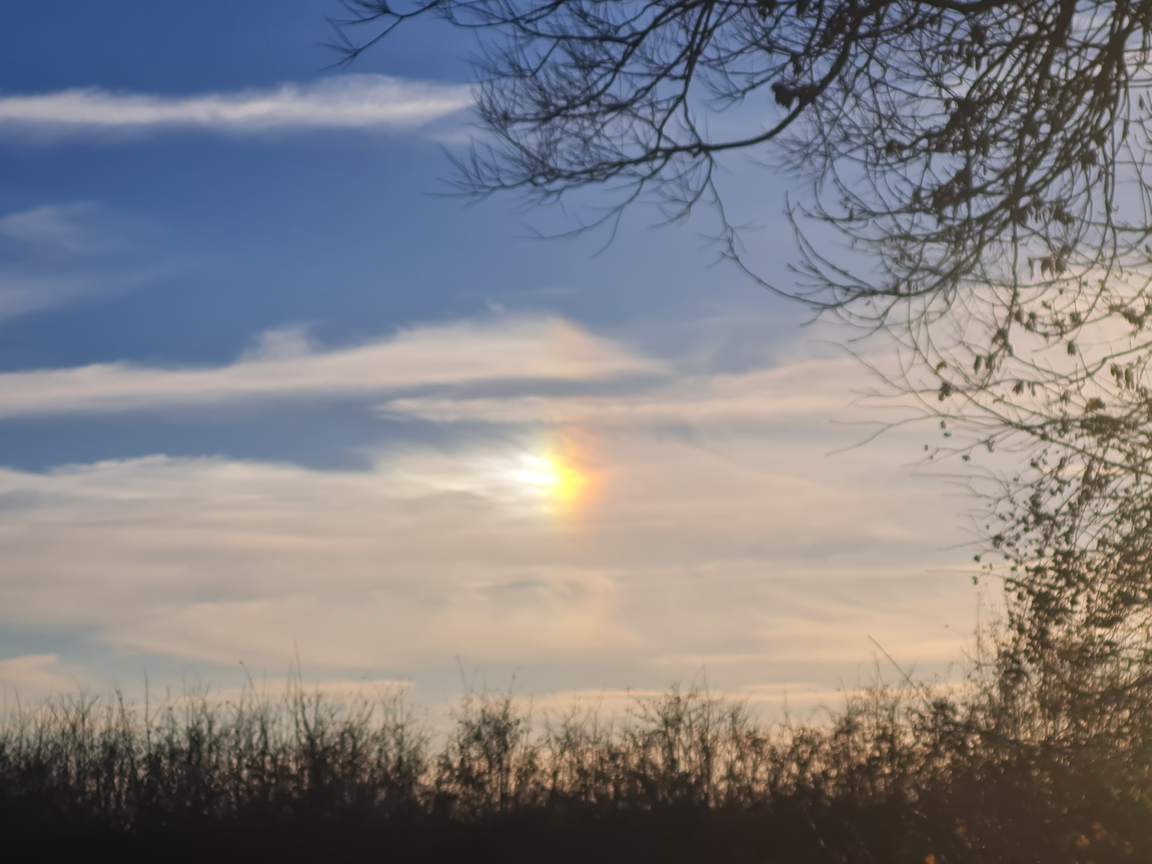 Photo of clouds with a rainbow effect